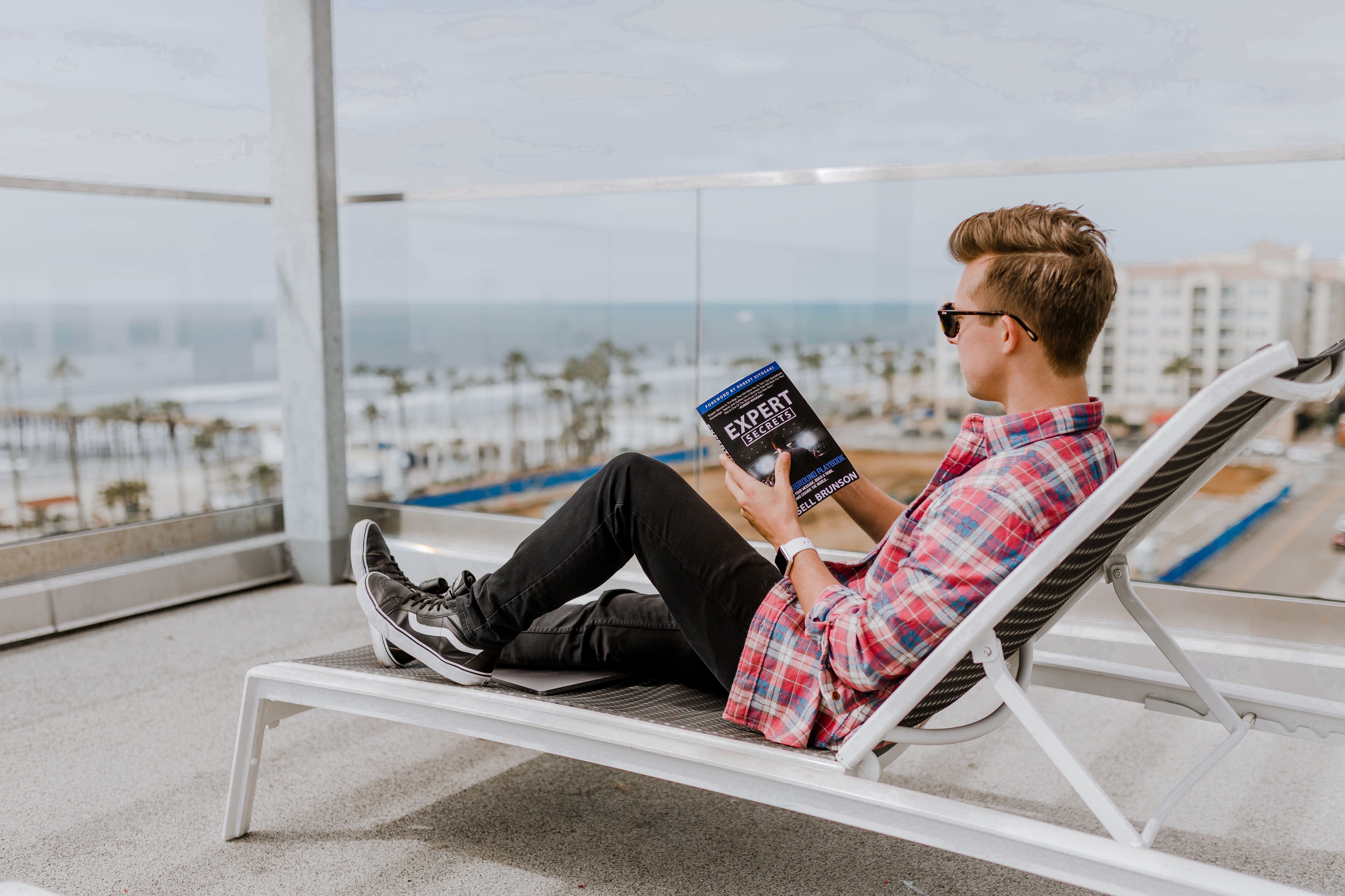 Man reading book by expert - Can you learn copywriting - Copify blog 2
