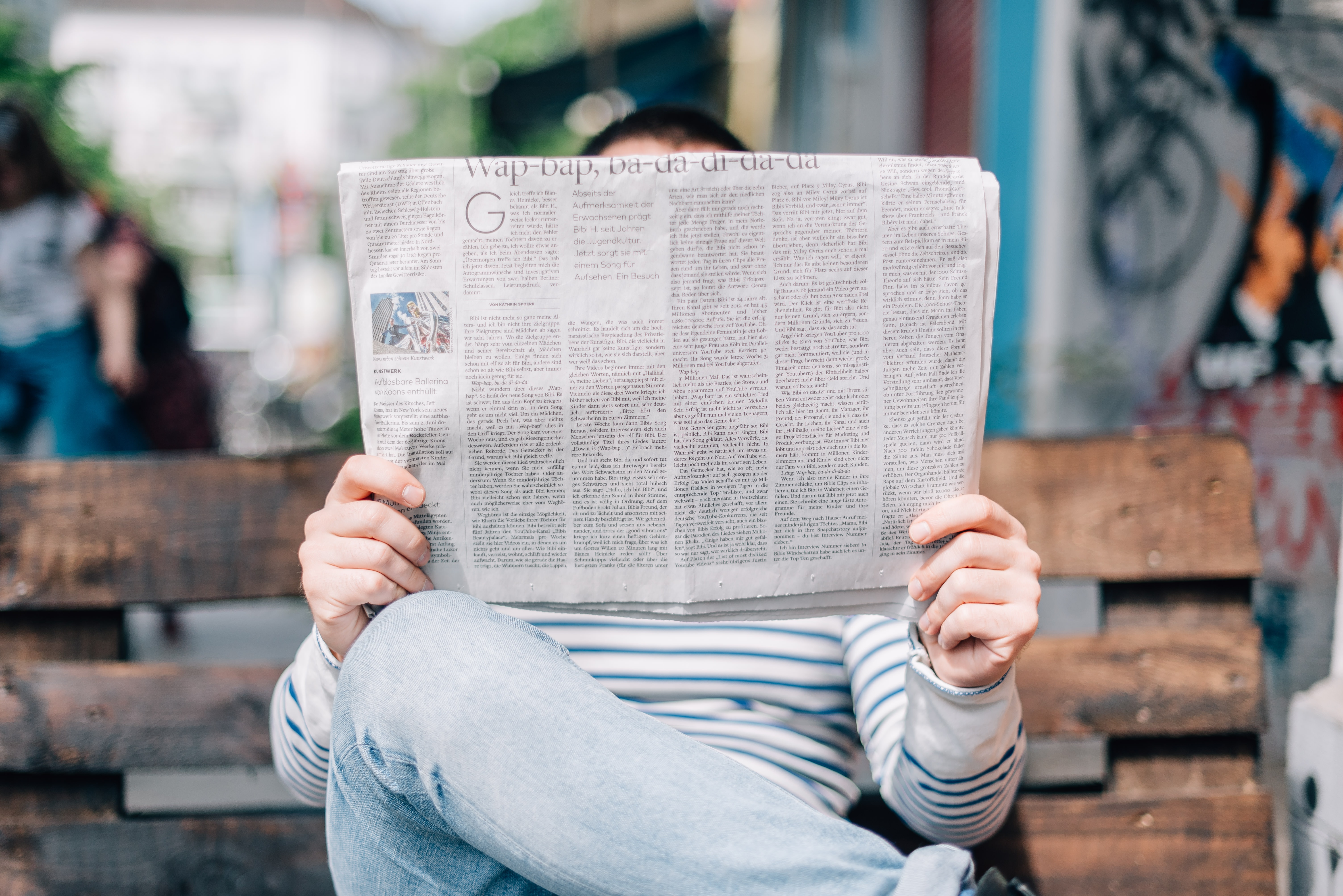 Man reading newspaper - Can you learn copywriting - Copify blog 3