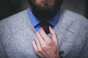 Man straightening tie - How to become a content writer - Copify blog