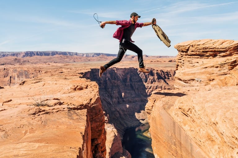 Man free jumping over crack in land - Topics for motivational blogs - Copify blog