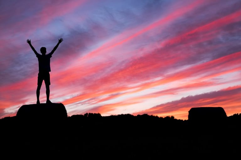 Someone standing on mountain top - Topics for motivational blogs - Copify blog