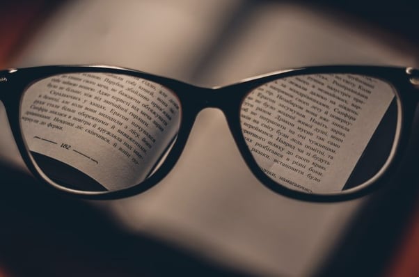Glasses on textbook - What-are-the-best-copy-editing-courses-Copify-blog-740x490-2
