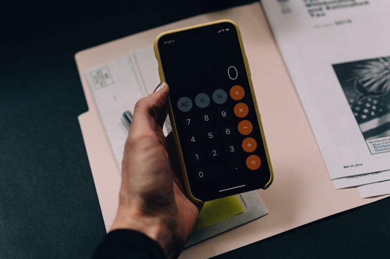 Image of someone using a calculator - What does CTR stand for in marketing - Copify blog