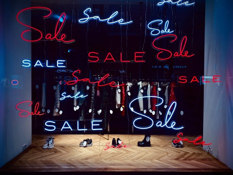 shop window with sale in different red and white fonts