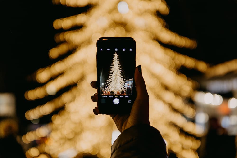 Image of a Chistmas tree captured on a smartphone camera - 5 best Christmas social media campaigns all wrapped up - Copify Blog