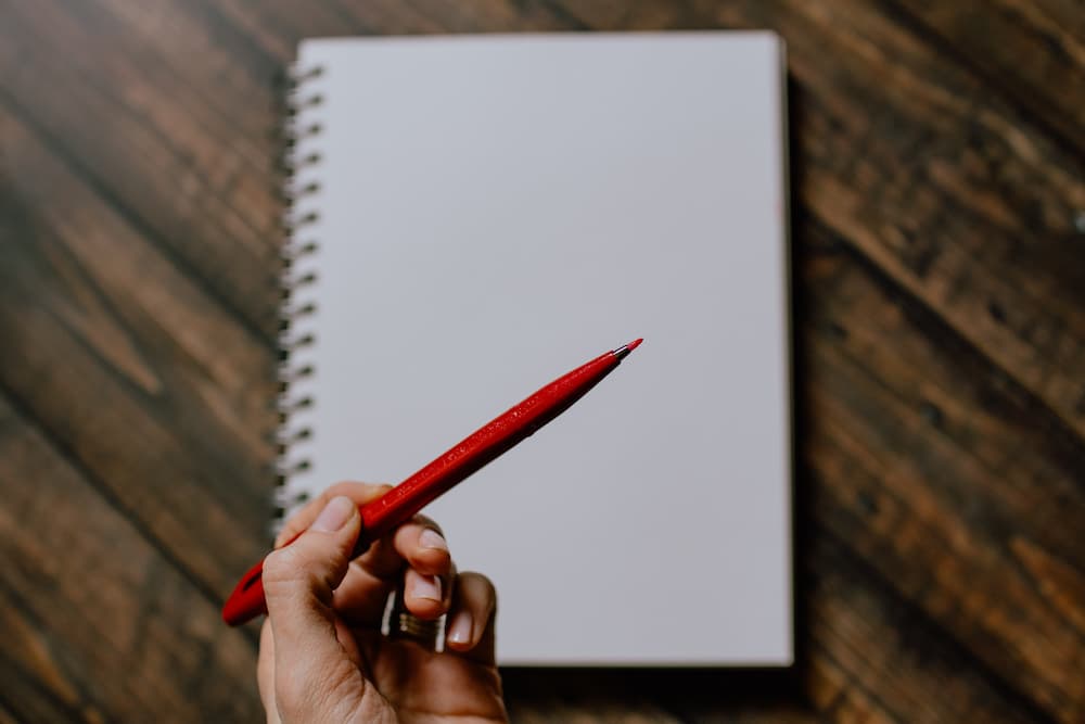 Red pen and white pages - Becoming a freelance editor – what you need to know - Copify blog