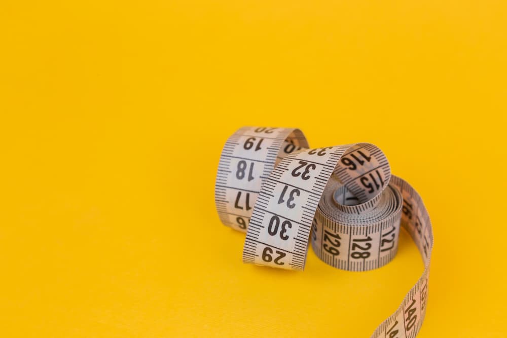 Tape measure on yellow background - How to measure SEO effectiveness - Copify blog