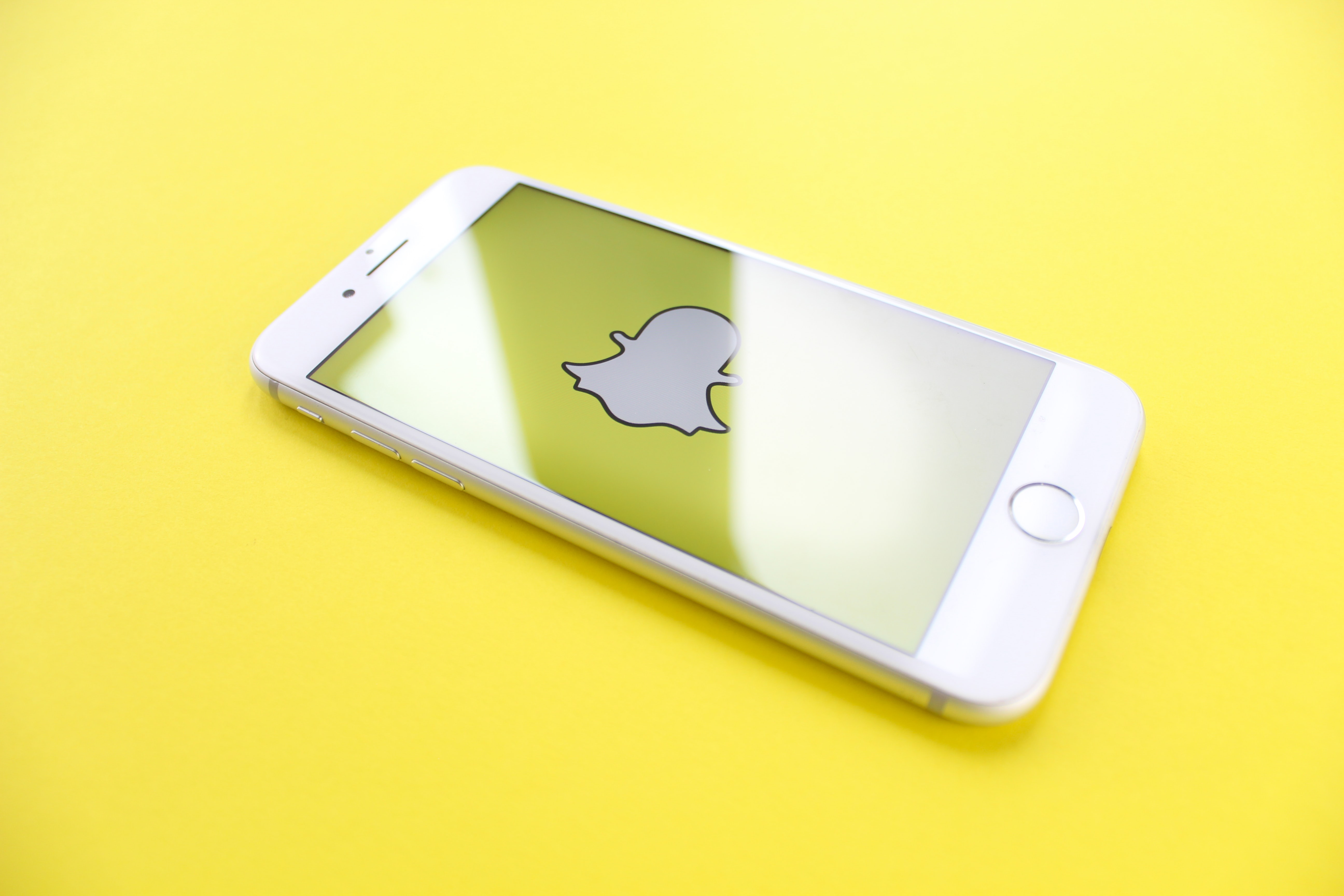 Snapchat logo on smartphone - What is content creation in social media - Copify Blog 1