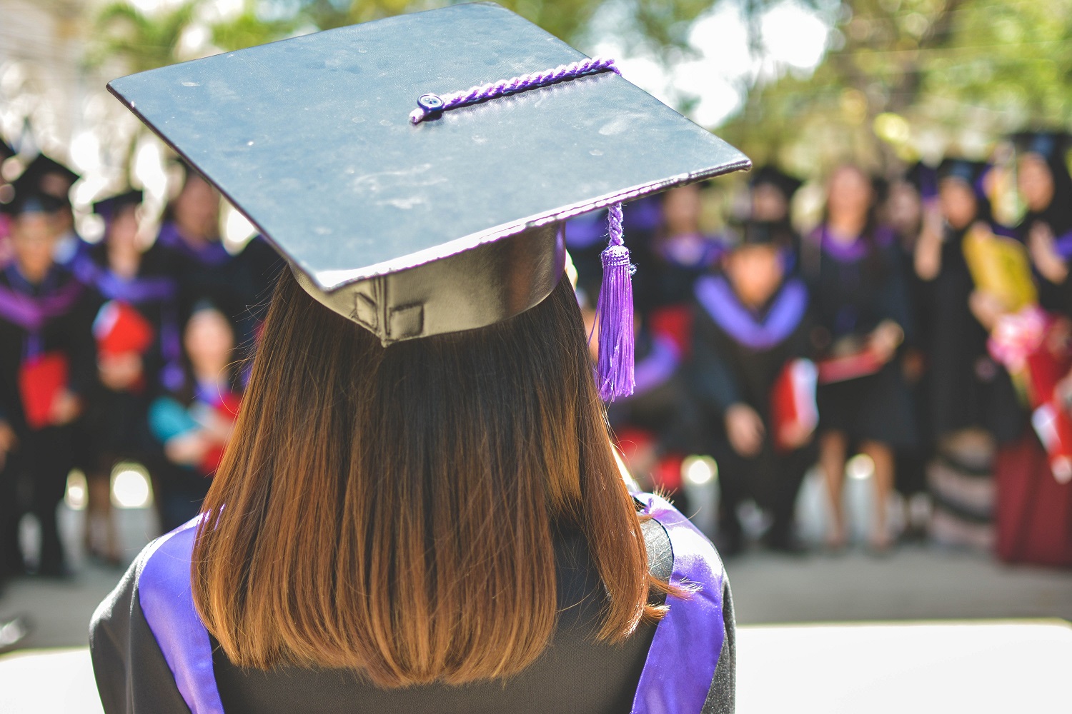 Back of womans head in graduation cap - Can I become a writer without a degree? - Copify Blog
