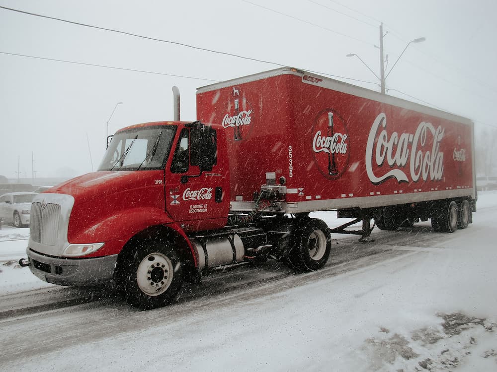 Coca-Cola truck in the snow - The best Christmas marketing taglines - Copify blog