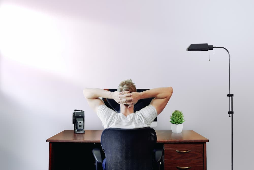 Man relaxing at desk - What is online copywriting all about? - Copify blog 1